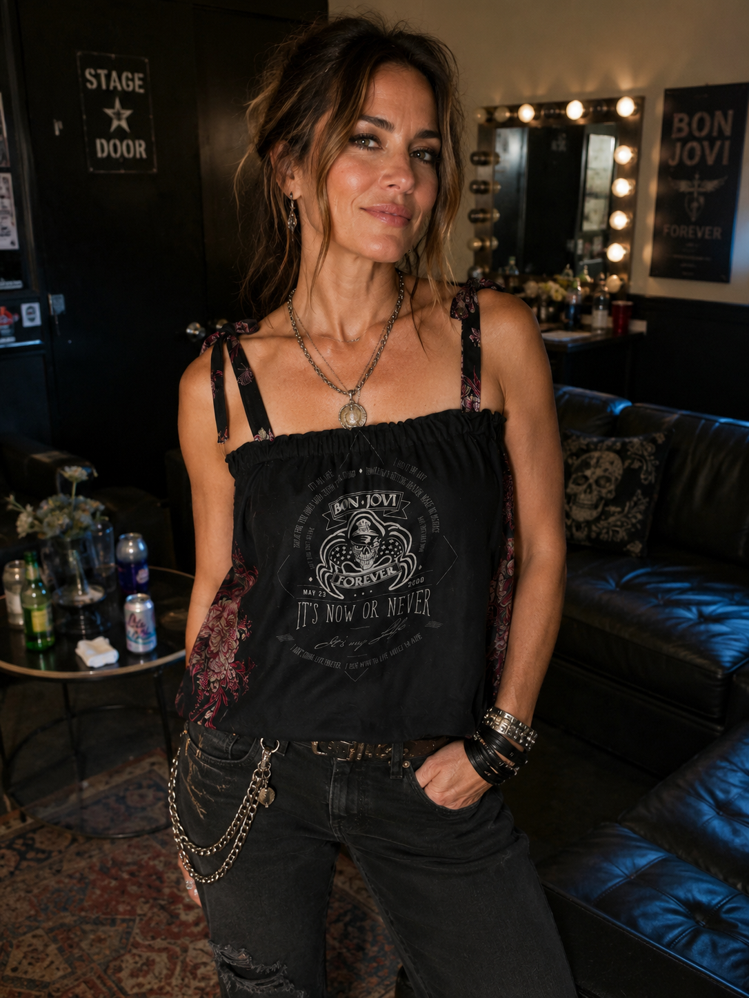 Woman wearing one-of-a-kind Bon Jovi concert tank in a backstage green room, styled with black jeans for a rock concert look.