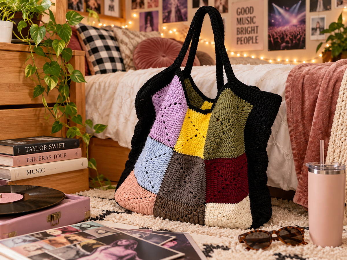 A handmade crocheted tote bag with a granny squares and black handles inspired by Eras Tour graphic.