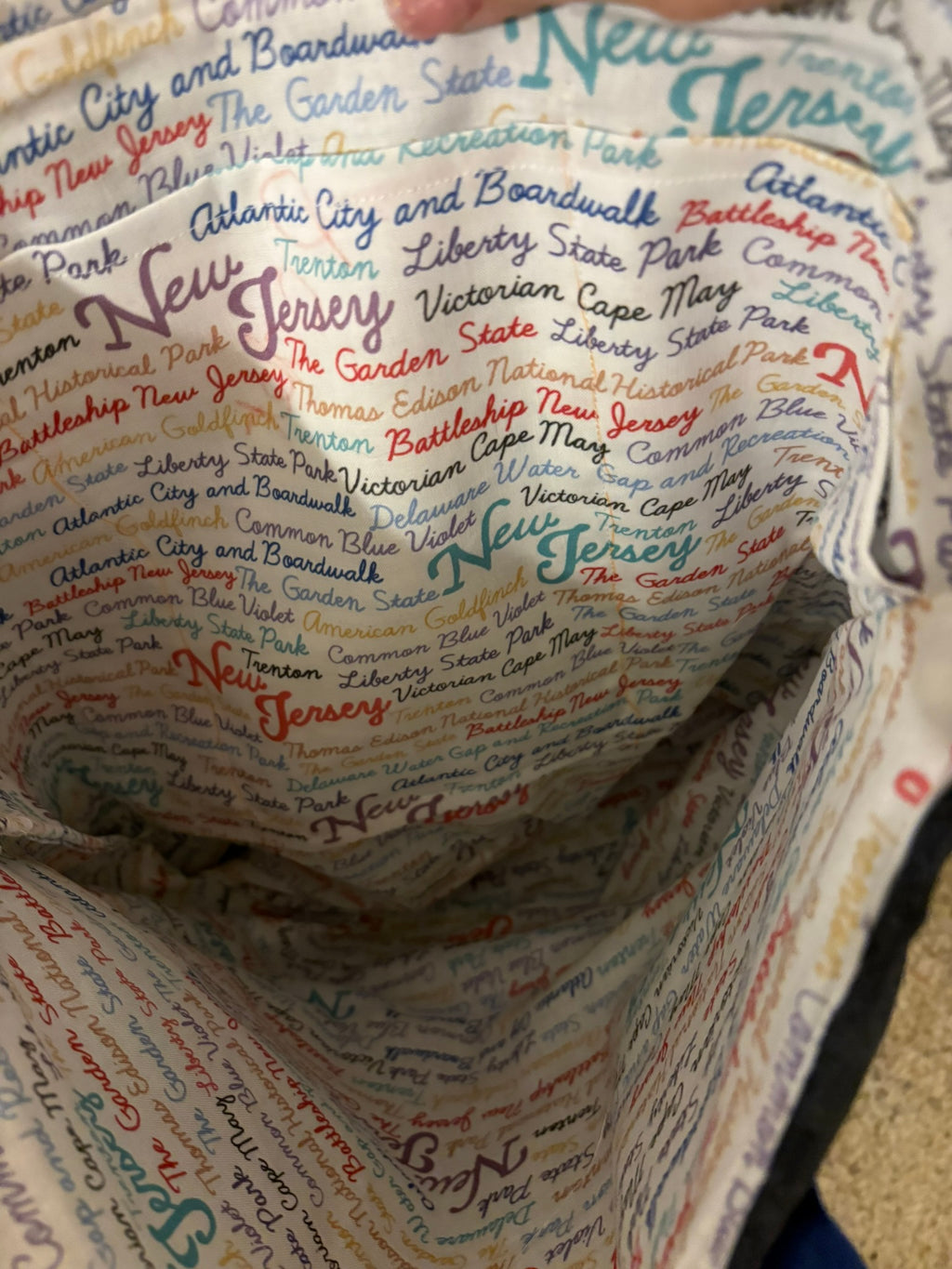 Interior has three pockets and an homage to everything New Jersey.