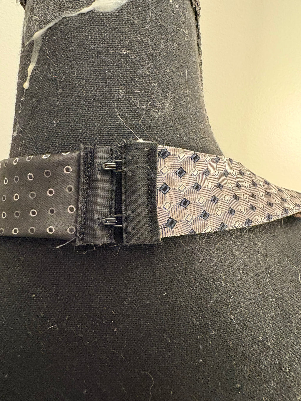 Hook and eye clasp at the neck.