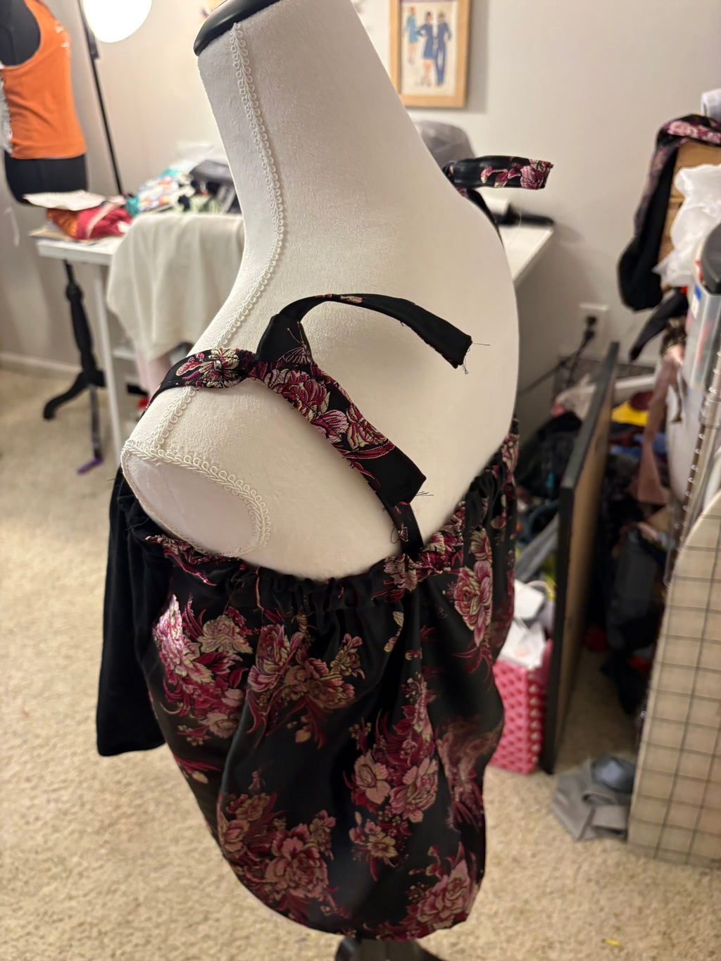 Side view of upcycled Bon Jovi tank highlighting the black floral brocade side panel and adjustable shoulder ties.