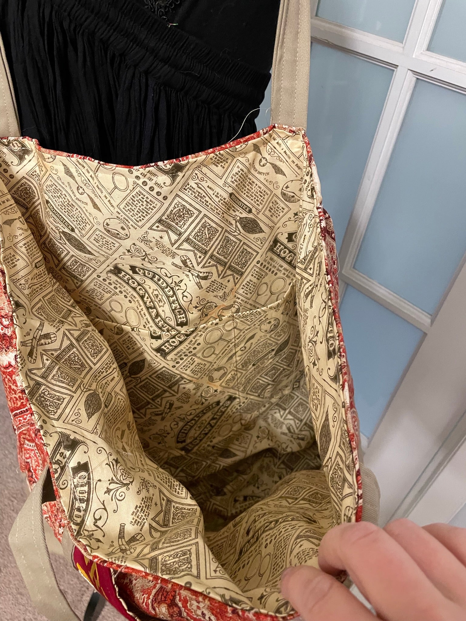 Fully lined with quidditch patterned-fabric, this bag has two large outer and six inner pockets.