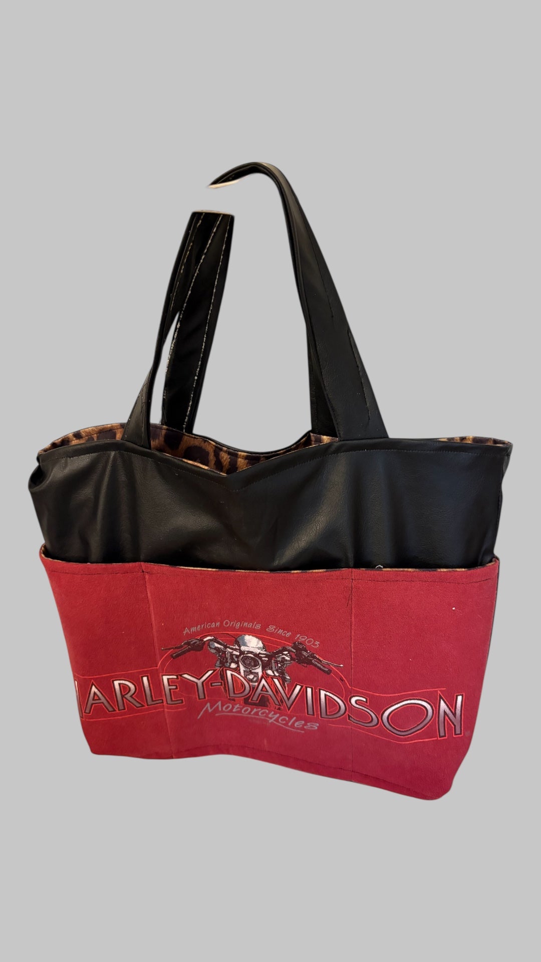 One of a Kind vegan leather and animal print bag with vintage-style Harley Davidson graphic on outer pocket.