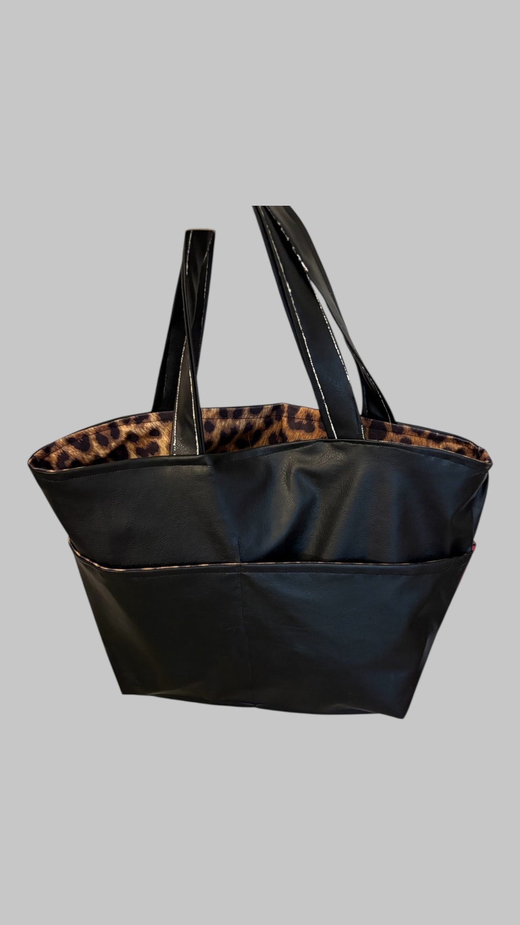  Vegan leather and animal print shoulder bag with five outer and one inner packet and Harley Davidson graphic on exterior.