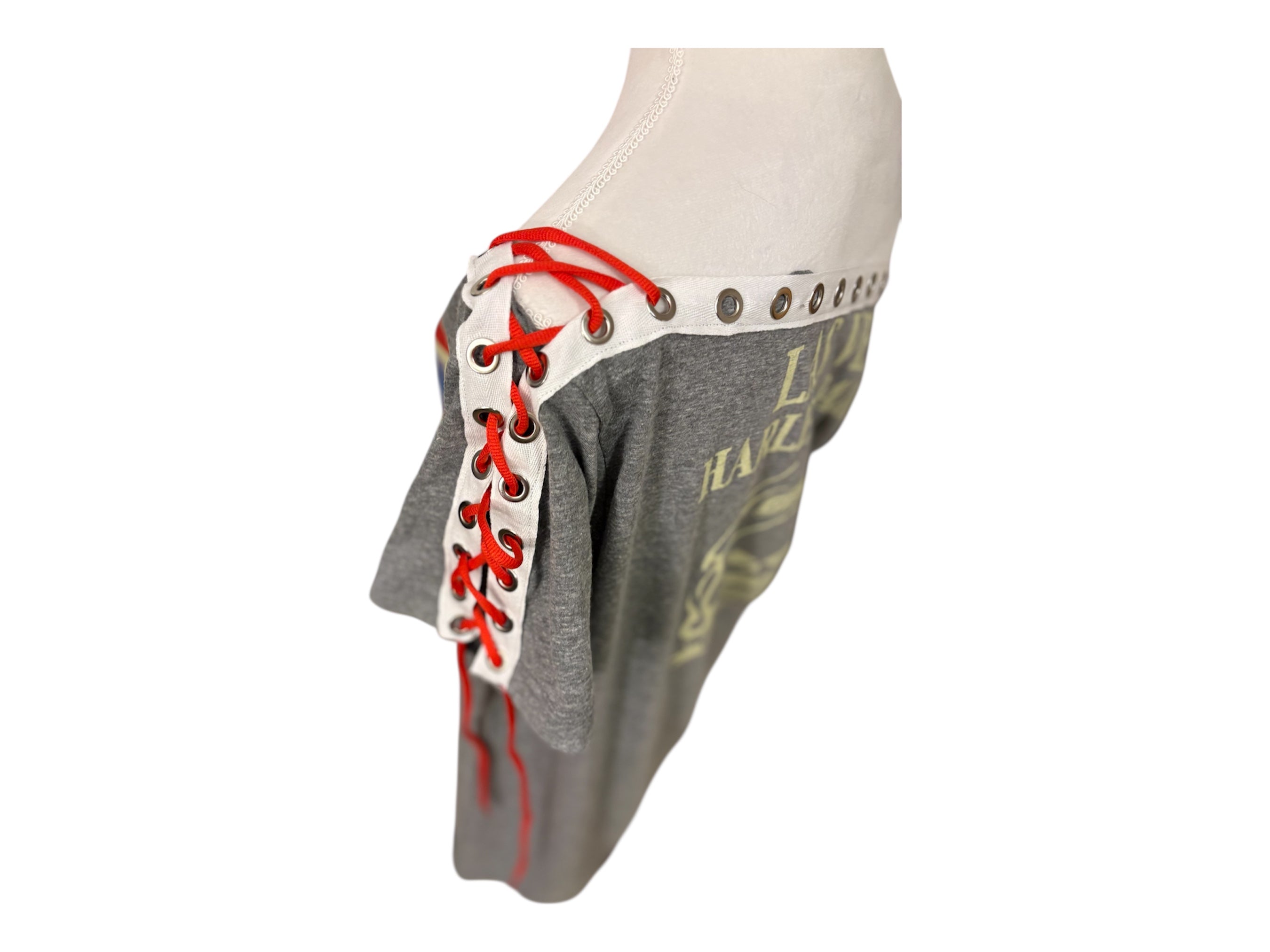 Grommet and lacing details on shoulders and bottom hem.