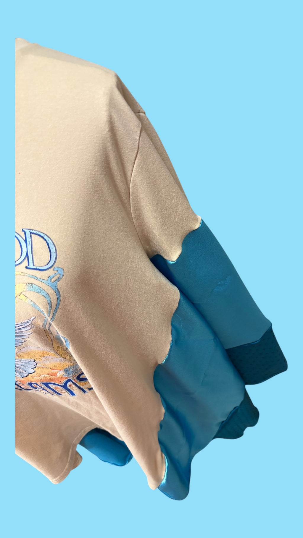 Fleetwood Mac graphic tee reimagined into a poncho with satin and rhinestones.
