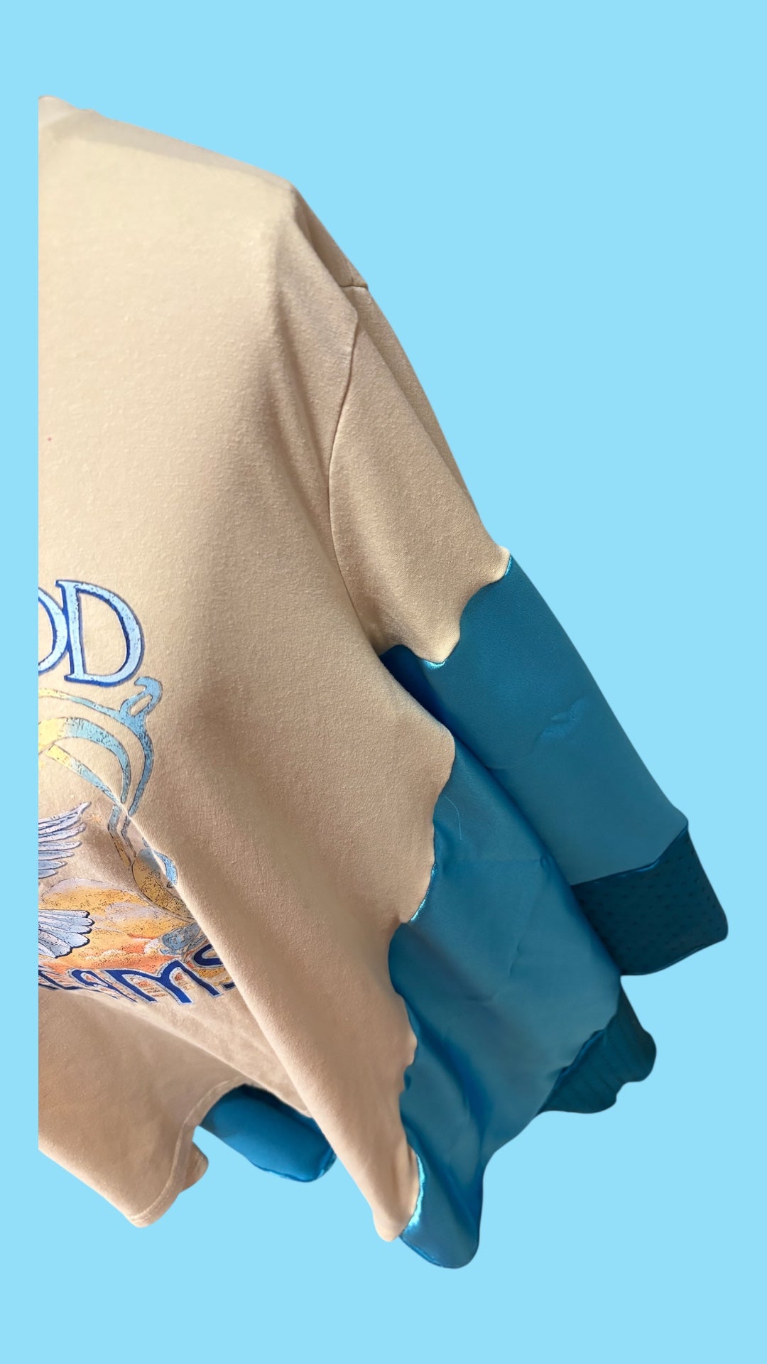 Fleetwood Mac graphic tee reimagined into a poncho with satin and rhinestones.
